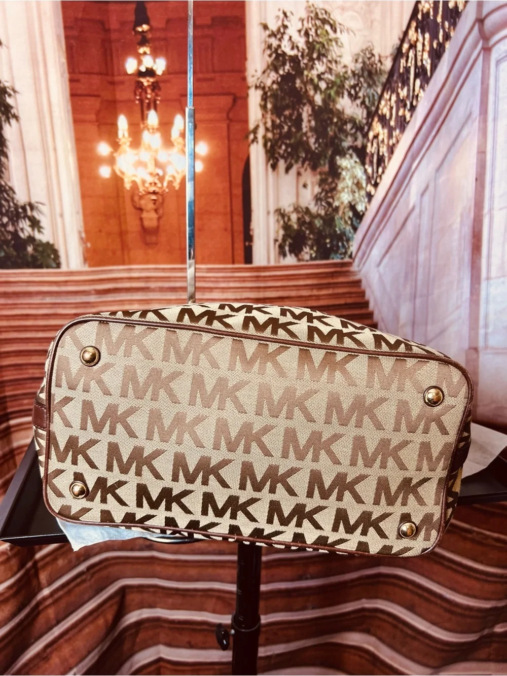 Michael Kors Jet Set tote features monogram canvas, contrasting leather straps